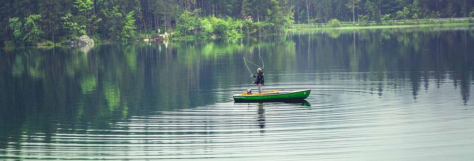 Person flyfishing in a boat.