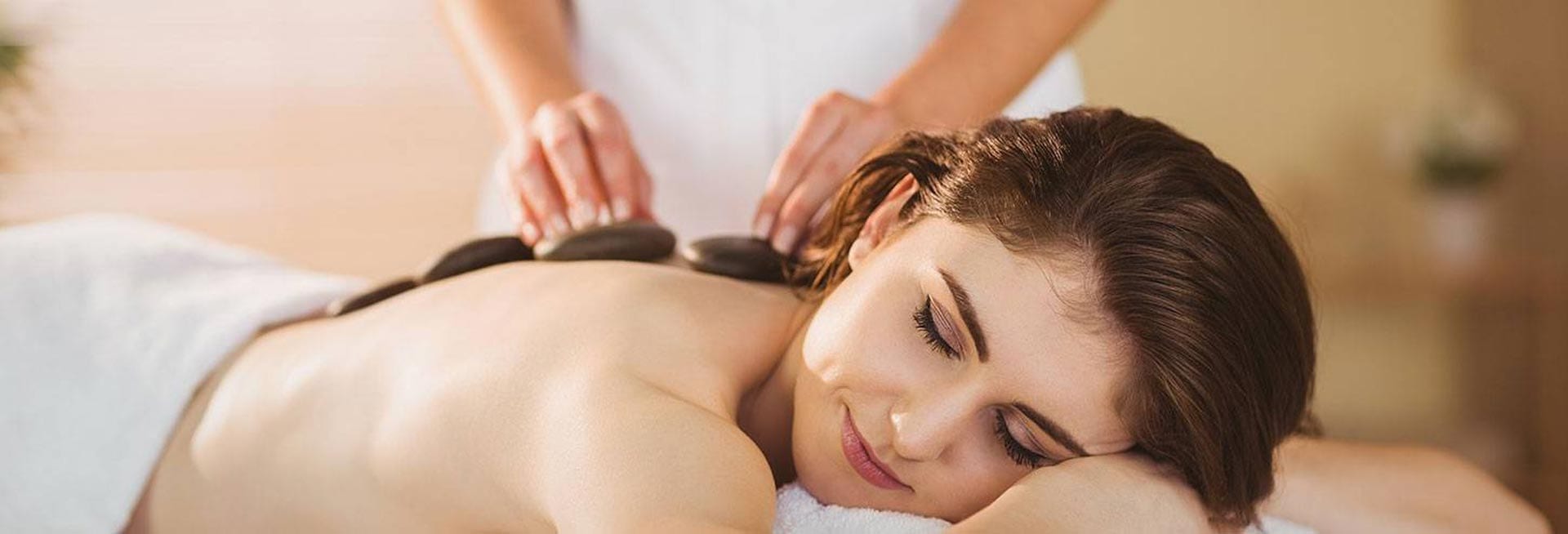 Woman getting a hot stone massage.